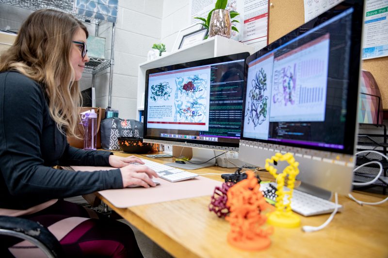 Virginia Tech biochemistry student working on a computer in a computational lab