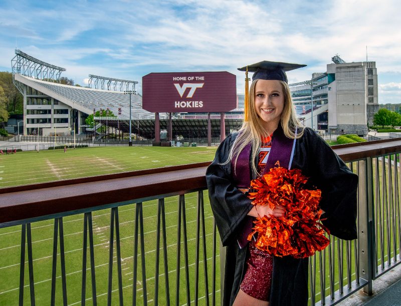 Senah Stephens standing in front of Virginia Tech stadium