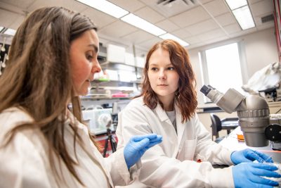 Chloe Lahondere working with student Ashlynn VanWinkle in biochemistry lab