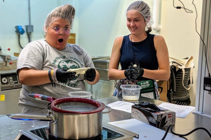 Two visiting 4H students make mozzarella 