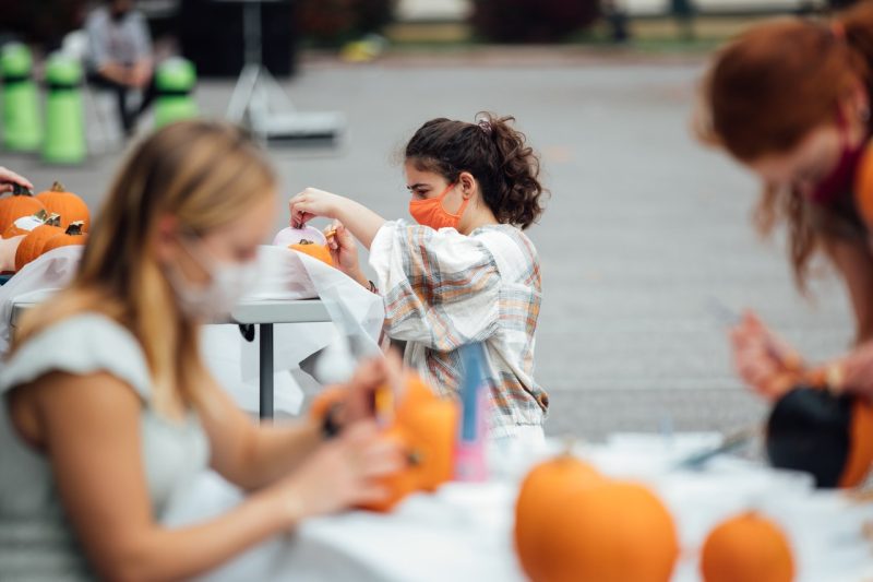 people painting pumpins