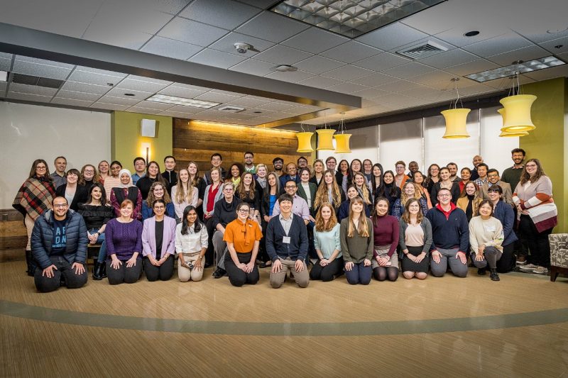 Large group of people posing in the commons at VMCVM.