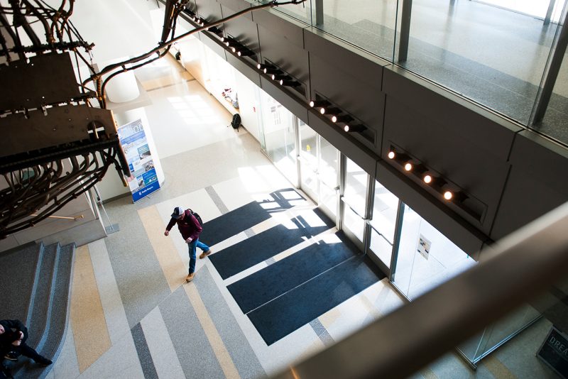 A student walks into a building