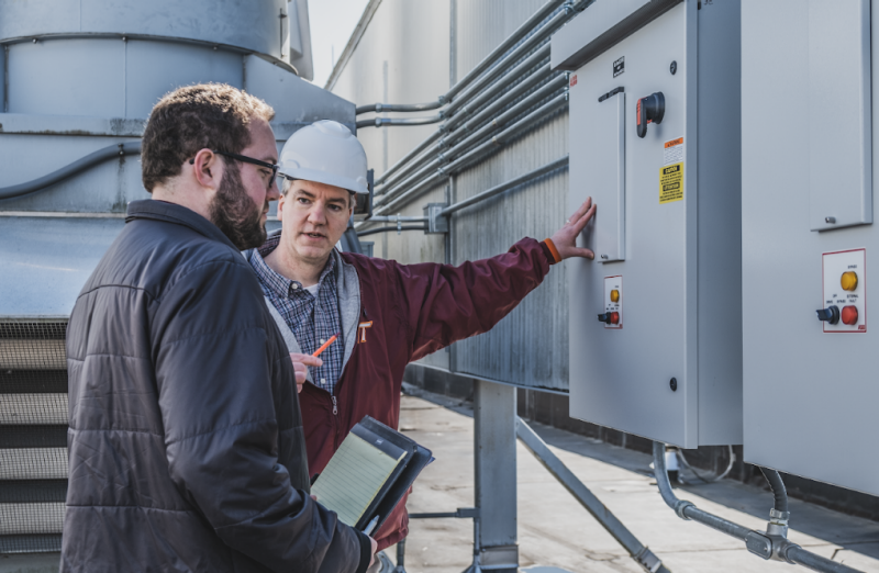 Daniel Webb and Lowell Jessee Jr. conduct an energy retrofitting project on the roof of Hahn Hall. 