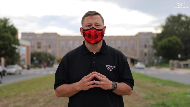 Frank Shushok Jr. speaks in front of Torgersen donning a mask