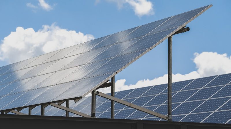 Solar panels atop the Perry Street Garage amidst white clouds and blue sky