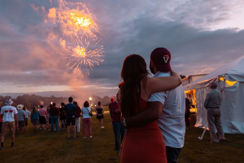 two people watching the fireworks over the Drillfield