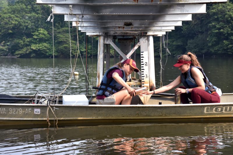 This shows two women in a small boat on a body of water.